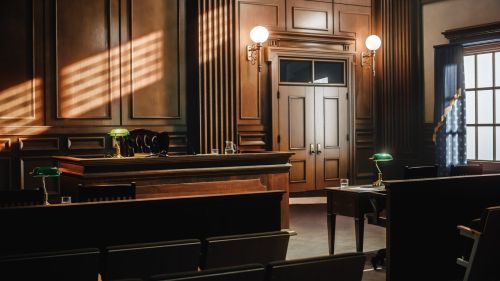 Empty American Style Courtroom. Supreme Court of Law and Justice Trial Stand. Courthouse Before Civil Case Hearing Starts. Grand Wooden Interior with Judge's Bench, Defendant's and Plaintiff's Tables. Failure to appear in court concept.