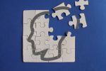 Human head on incomplete puzzles. Dementia, memory loss, mental health and Alzheimer concept