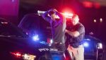 Police officer with a search warrant making an arrest.