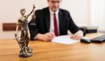 Lawyer signing paperwork at the office