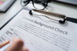 Hand Filling Criminal Background Check Application Form - Expunge Criminal Record Concept